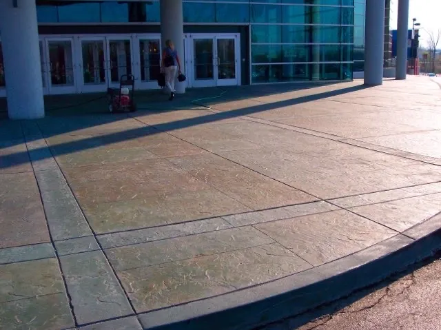 Large stamped concrete overlay entrance plaza at commercial building