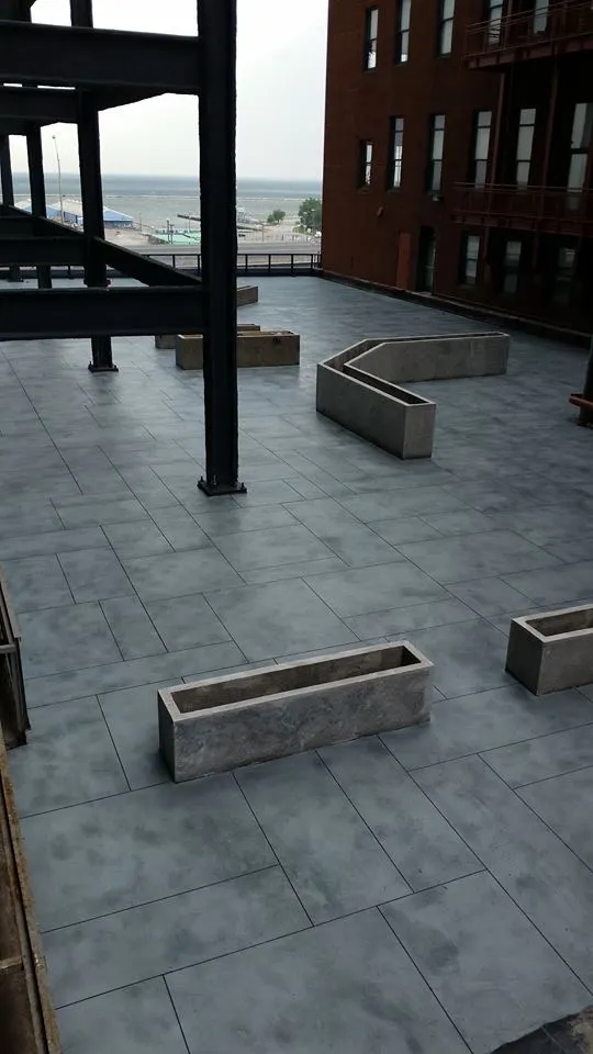 Decorative concrete overlay outdoor walkway with rectangular tiles